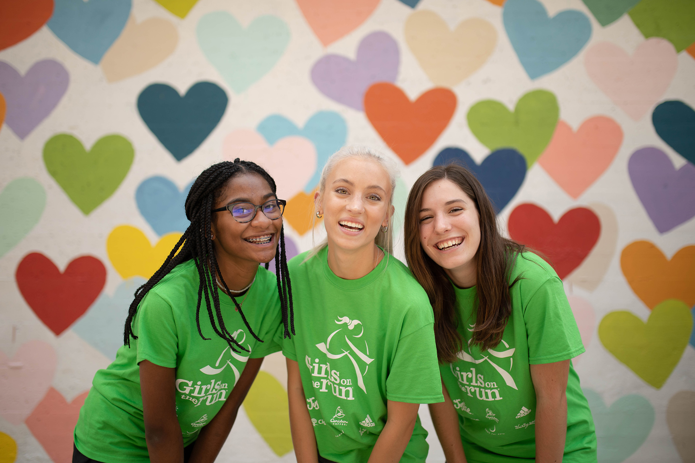Three smiling Girls on the Run junior coaches  